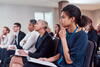 people sitting in chairs attending a class